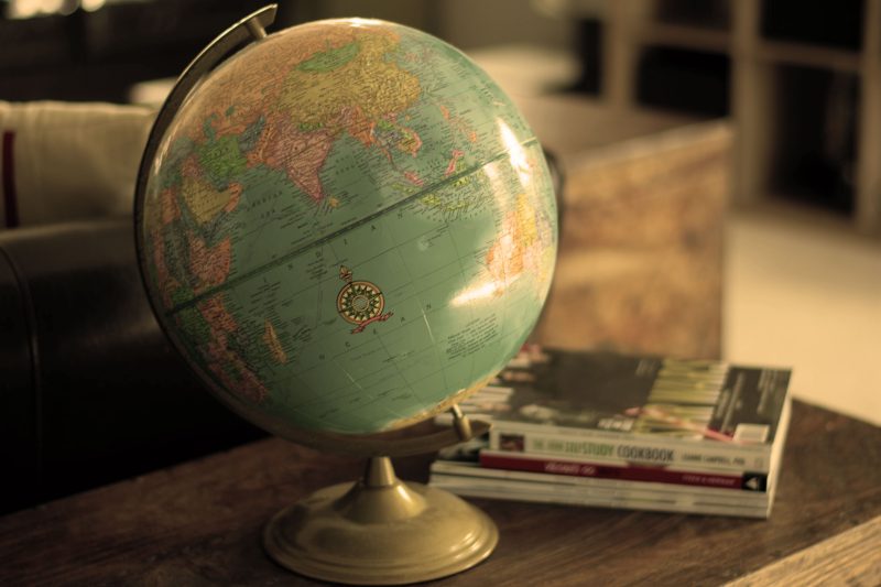 Global on desk with books