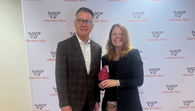 President Sands (left) presents and Ginny Ford (right) with an award